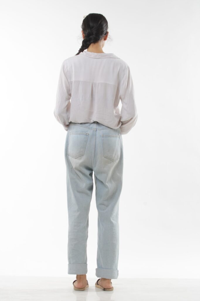 a woman standing in front of a white background