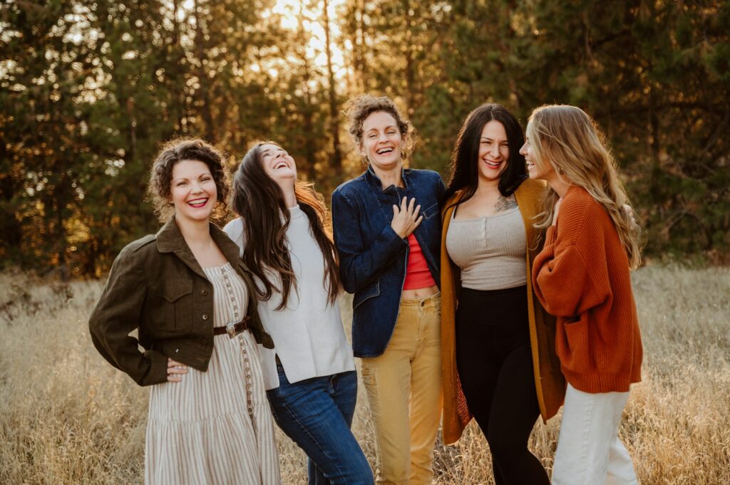 A group of women standing next to each other in a field