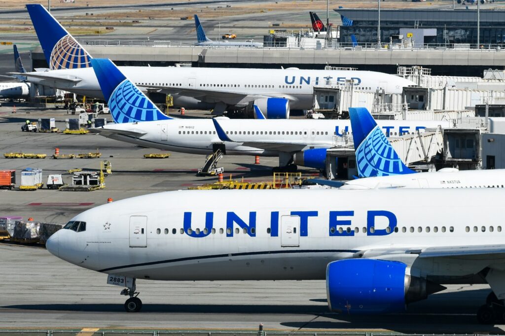 A bunch of airplanes that are on a runway