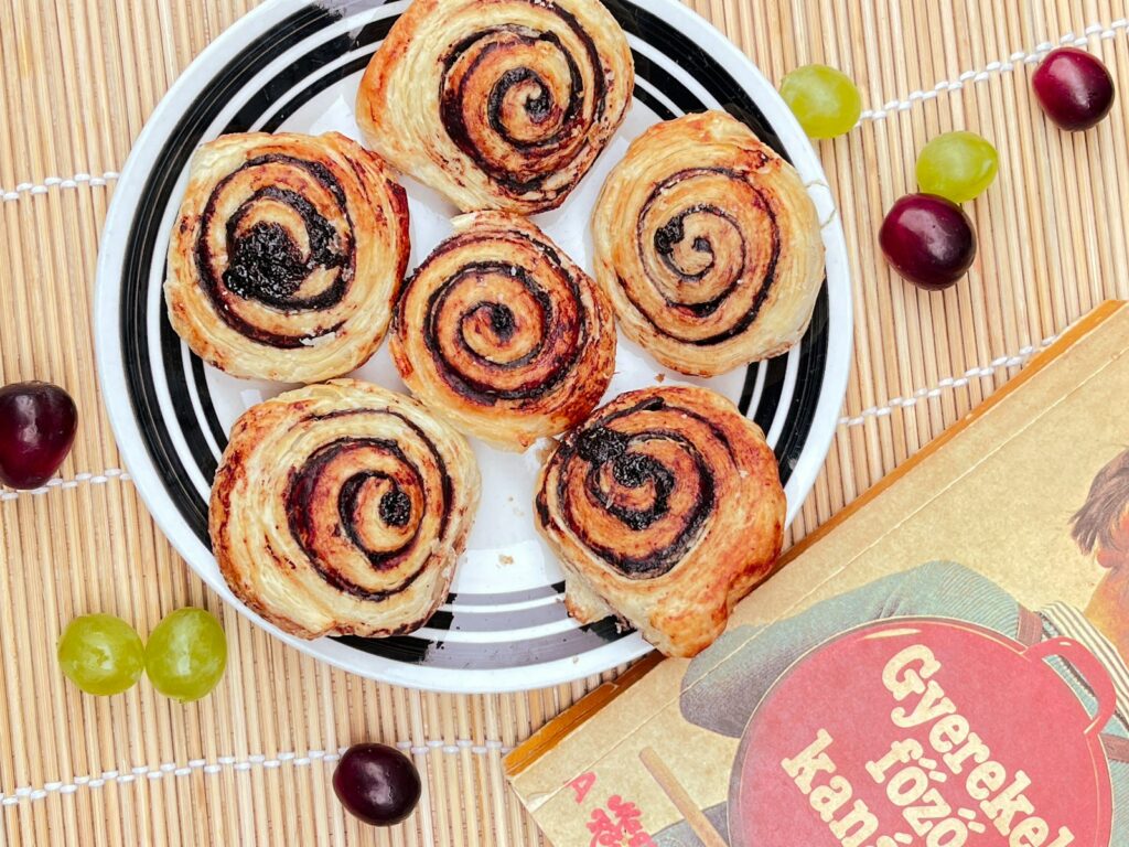 A plate of pastries and a book on a table