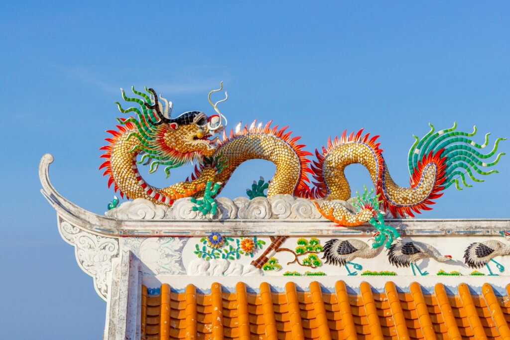 a dragon statue on top of a building