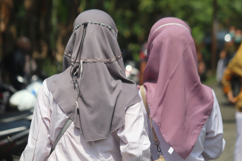two women in hijabs walking down the street