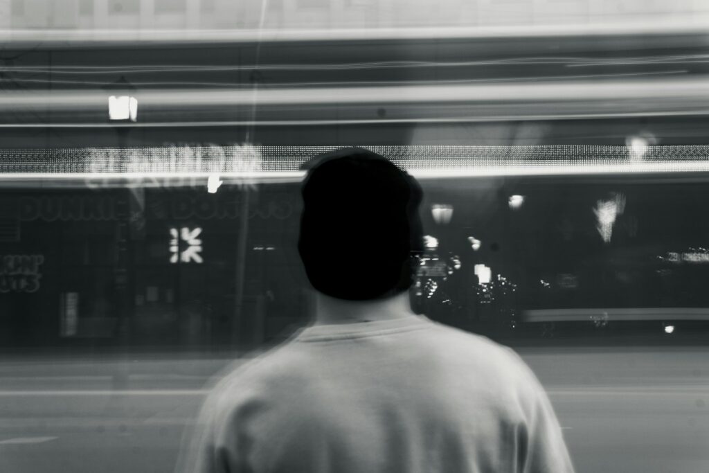 a man standing in front of a store window