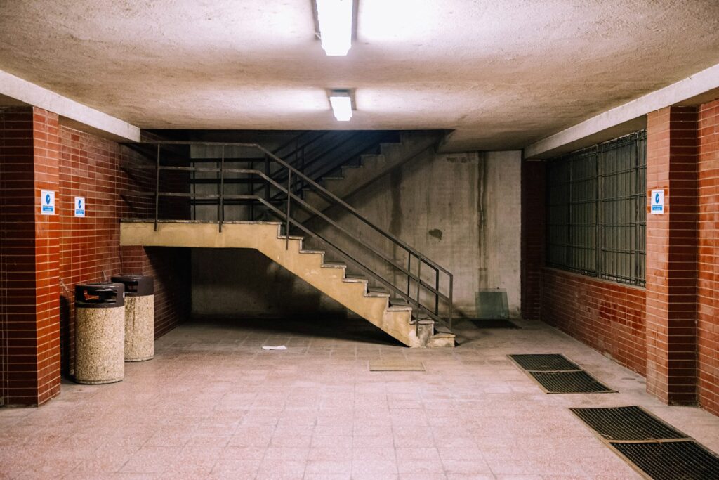 brown concrete staircase with stainless steel railings