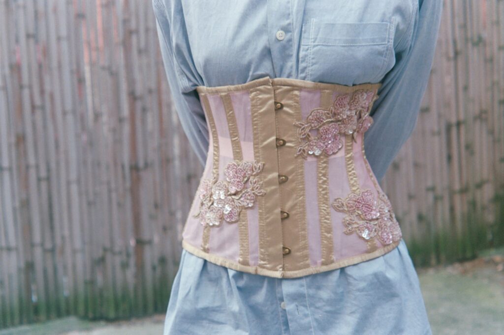 a woman wearing a corset made of fabric