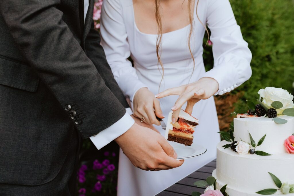 a man and a woman cutting a cake together