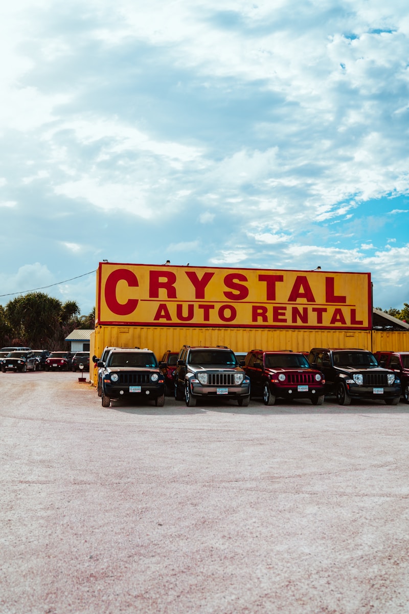 a car dealership with cars parked in front of it