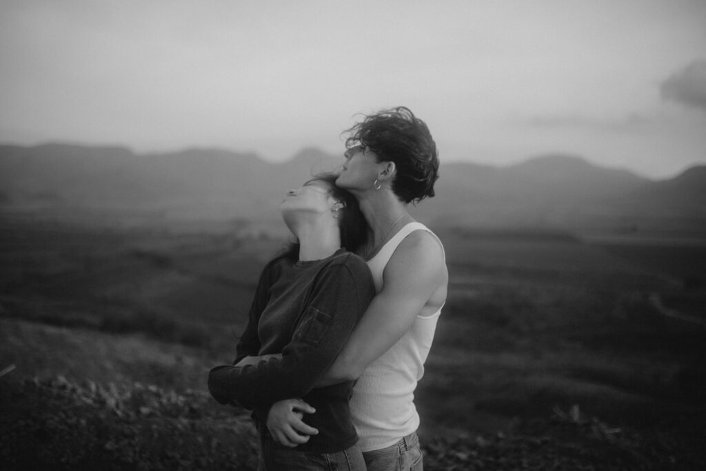 a man and a woman standing in a field