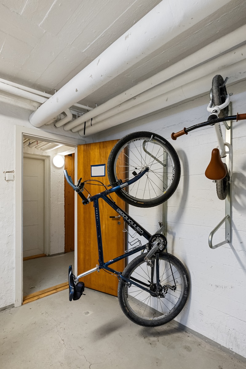 A bike hanging on a wall in a garage