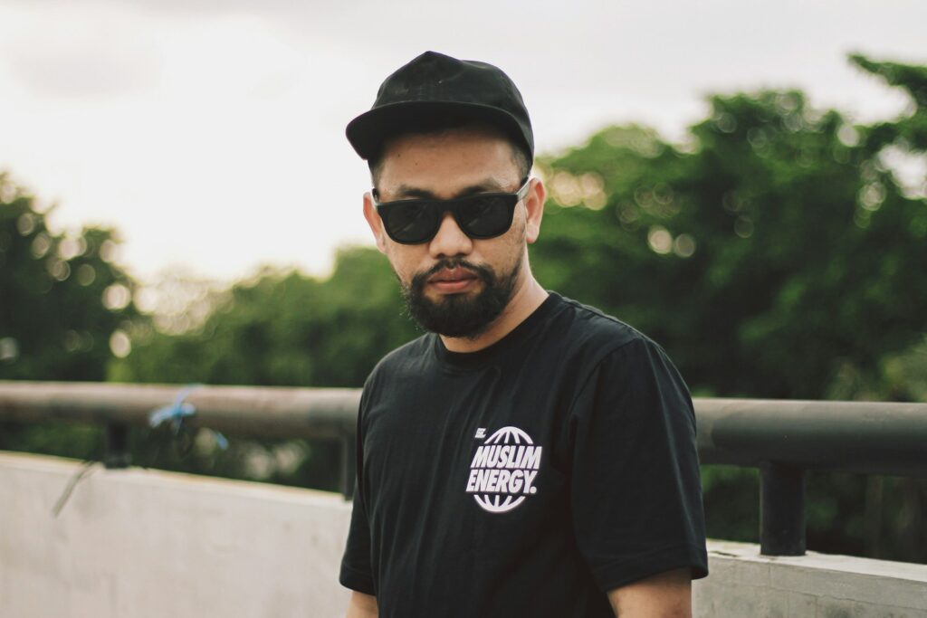 a man wearing a black hat and sunglasses