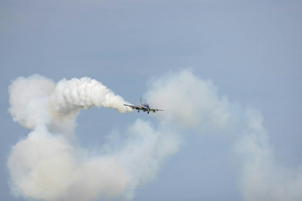 a plane is flying in the sky with a lot of smoke coming out of it