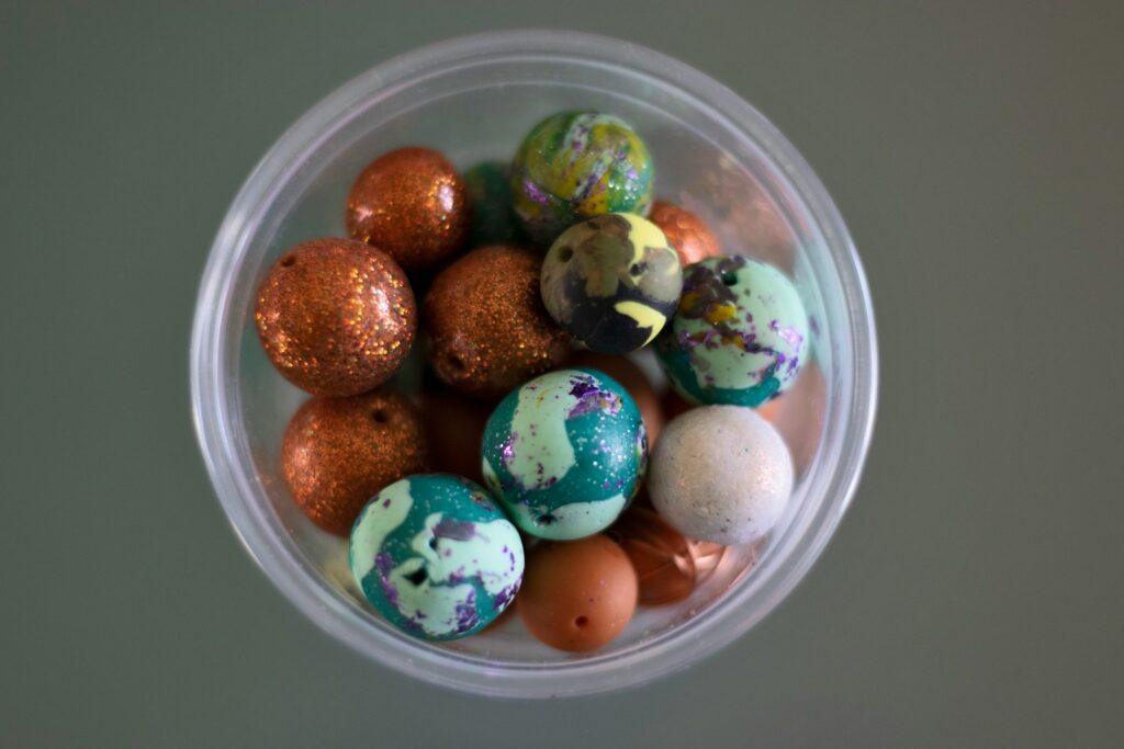 a plastic container filled with lots of different colored eggs