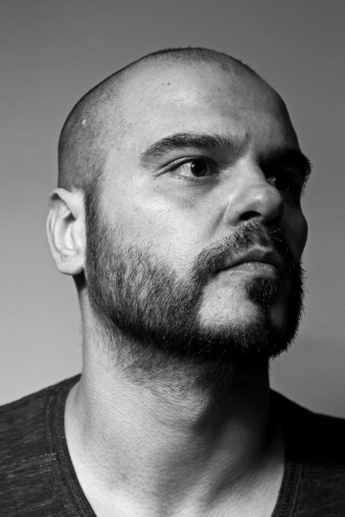 a black and white photo of a man with a bald head