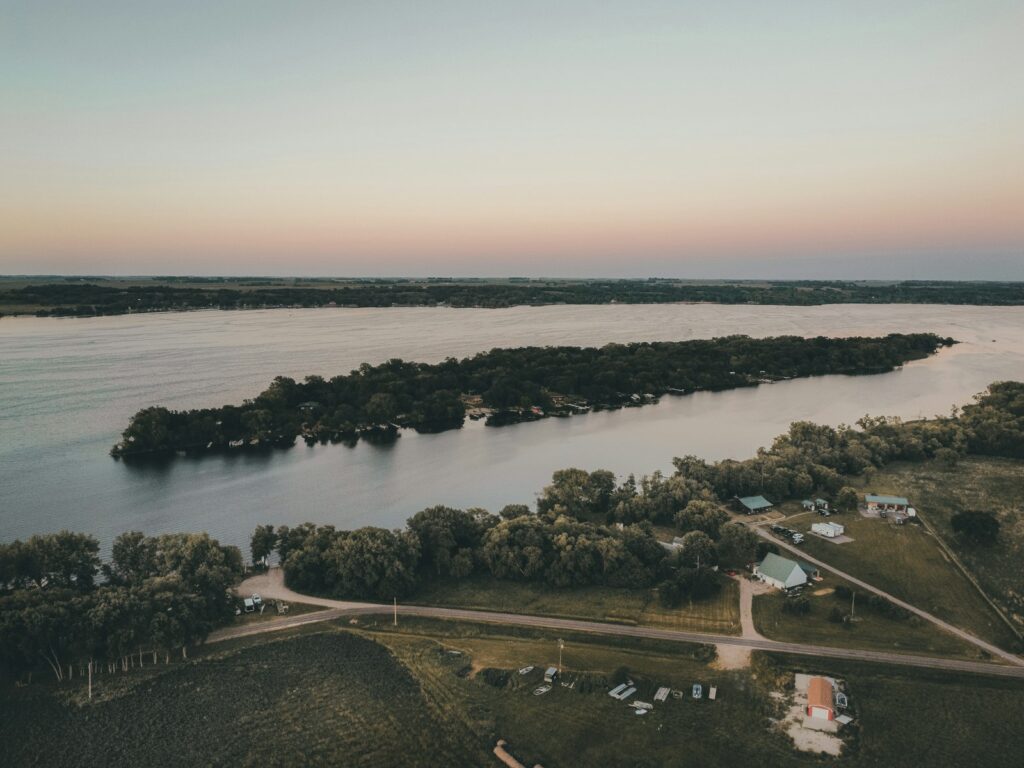 a lake surrounded by trees and a road