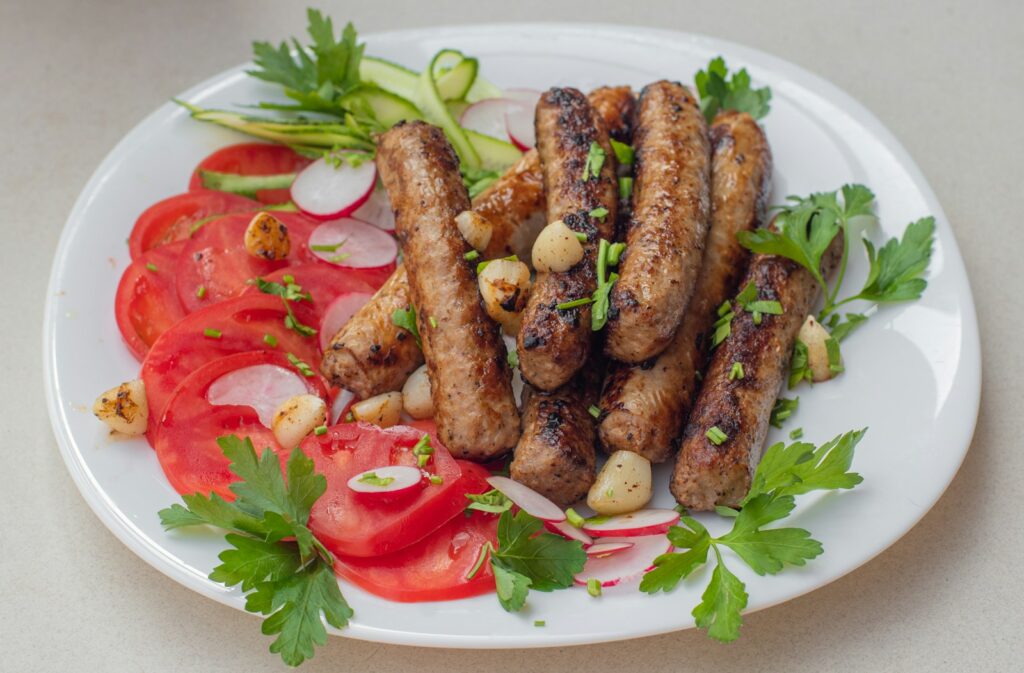a white plate topped with meat and veggies