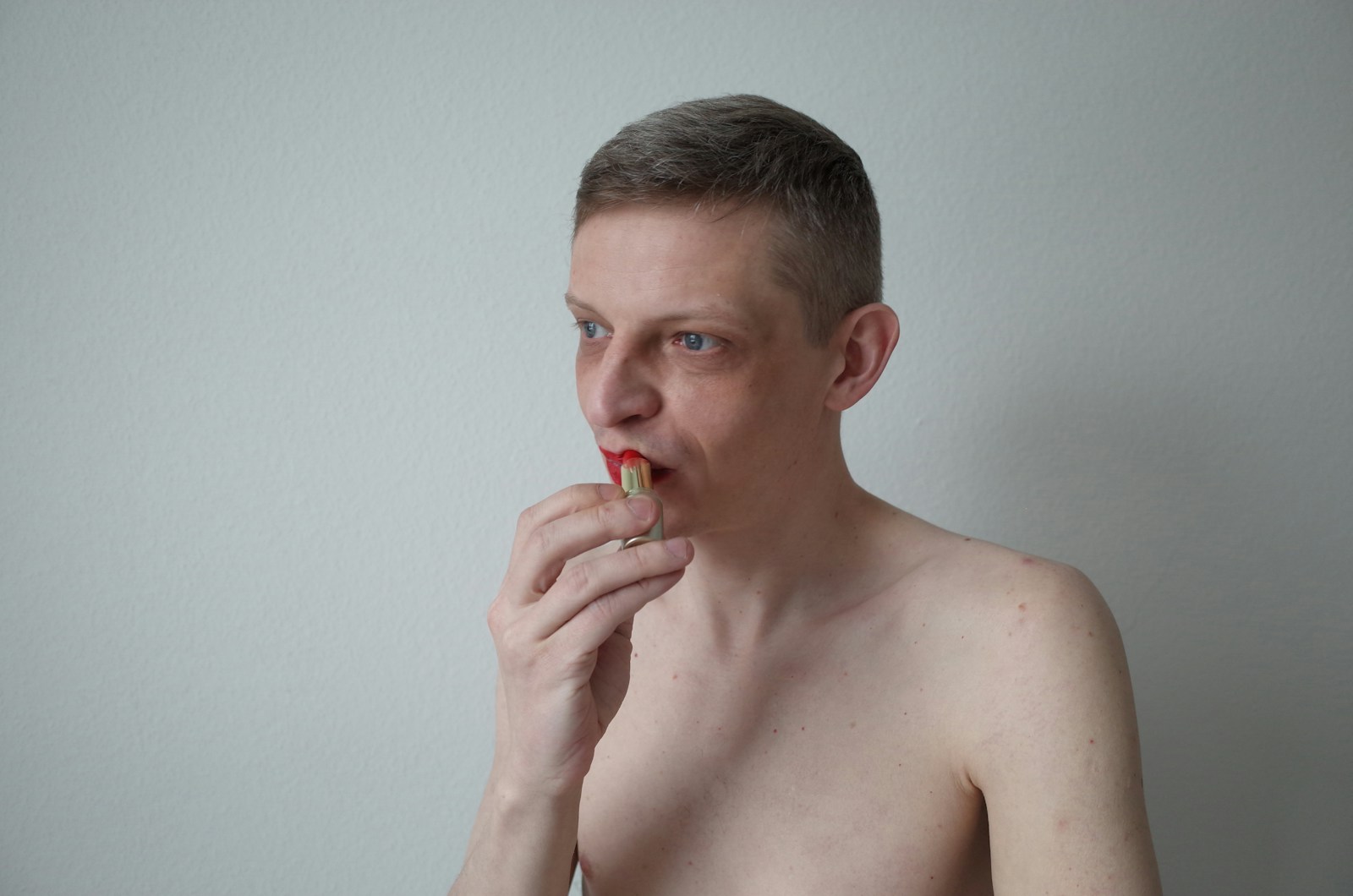 Man is eating something, possibly a piece of food.