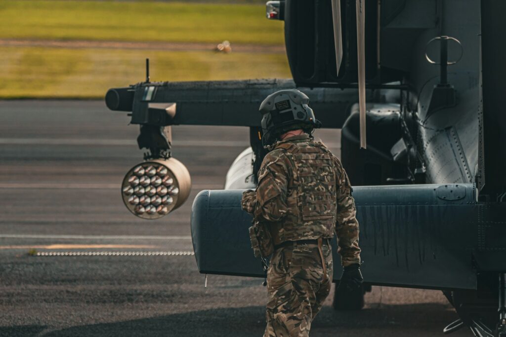 A man standing next to a helicopter on a runway