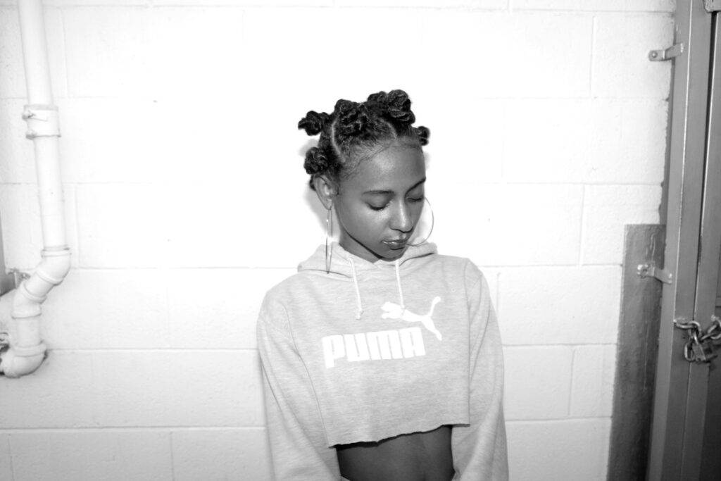 grayscale photography of woman wearing crop top sweatshirt