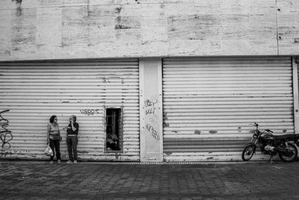two people standing in front of a garage door