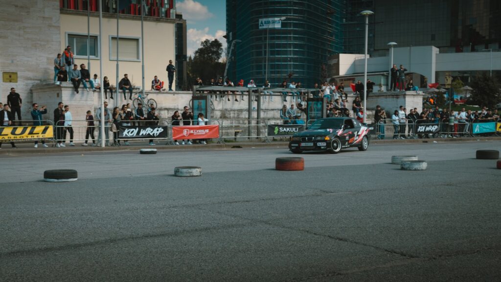 a car driving down a race track in front of a crowd
