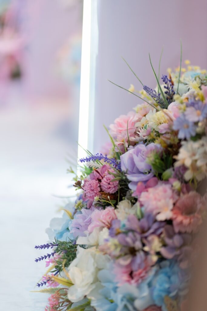 Beautiful pastel flowers decorate a white surface.