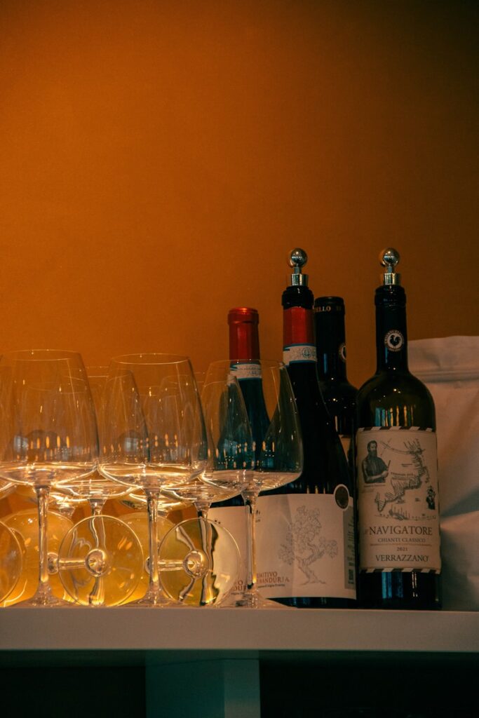 Wine bottles and glasses are neatly arranged.