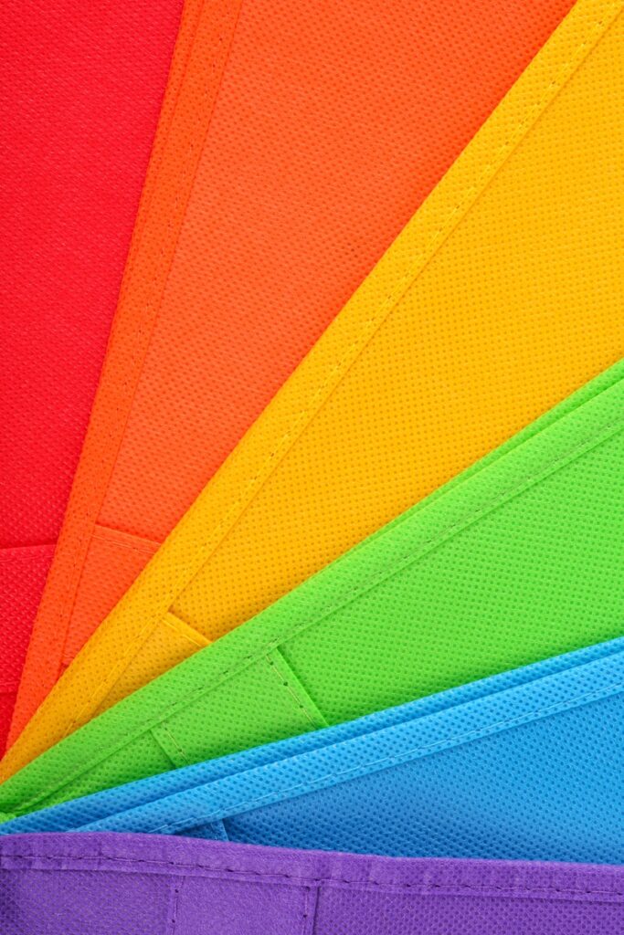 A close up of a rainbow colored umbrella