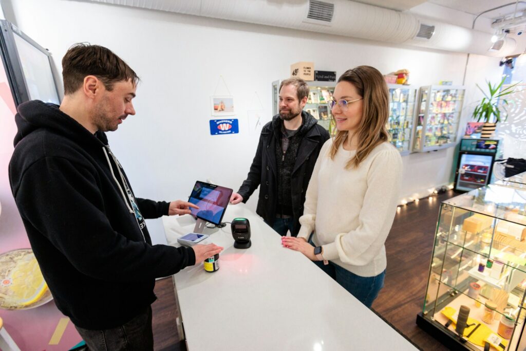 a group of people standing around a counter in a store