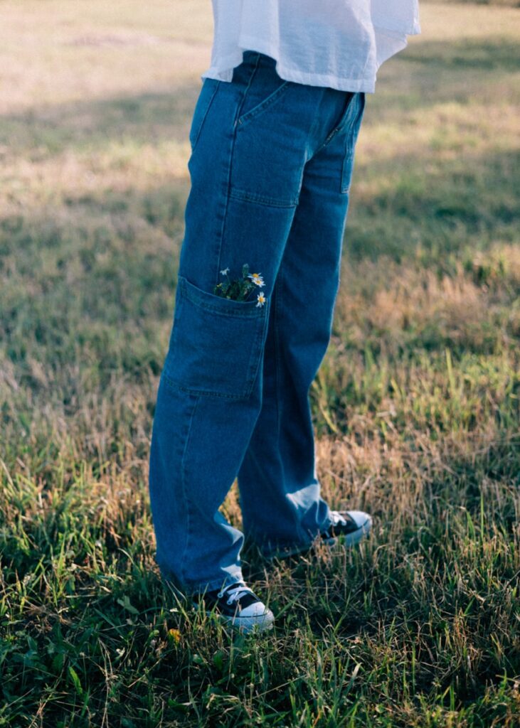 A person standing in a field holding a frisbee