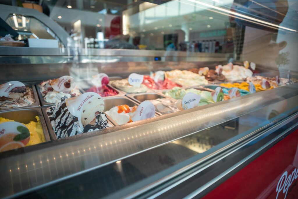 Delicious assortment of colorful gelato flavors beautifully presented in an ice cream shop display.