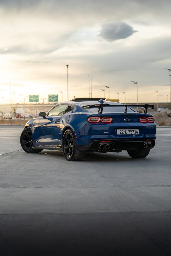 A striking Chevrolet Camaro parked outdoors in Erbil, captured against a moody sunset backdrop.