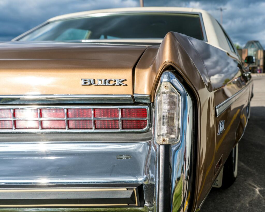 Close-up of a vintage Buick car rear showcasing classic chrome details and distinctive design.