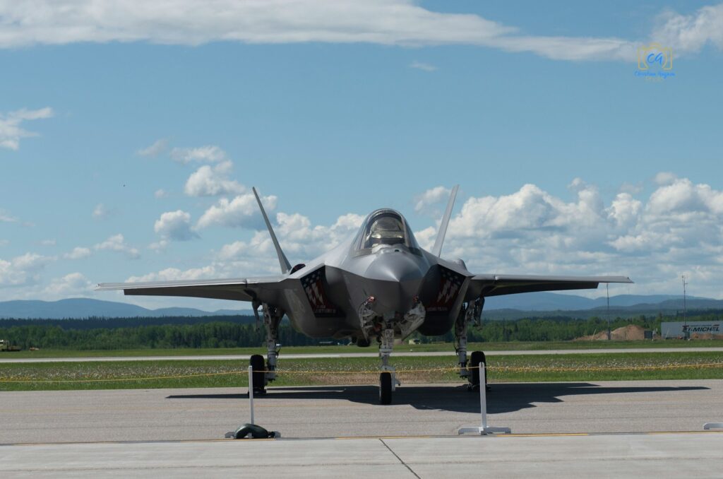 a fighter jet sitting on top of an airport tarmac