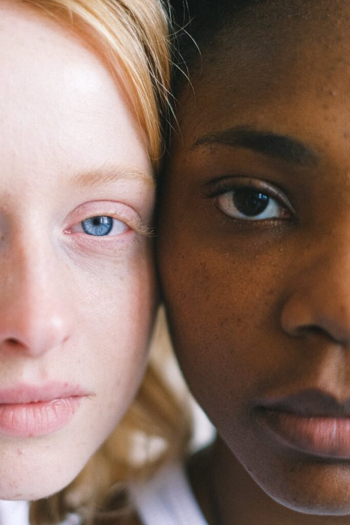 Intimate close-up of two women of different ethnicities showcasing diversity.