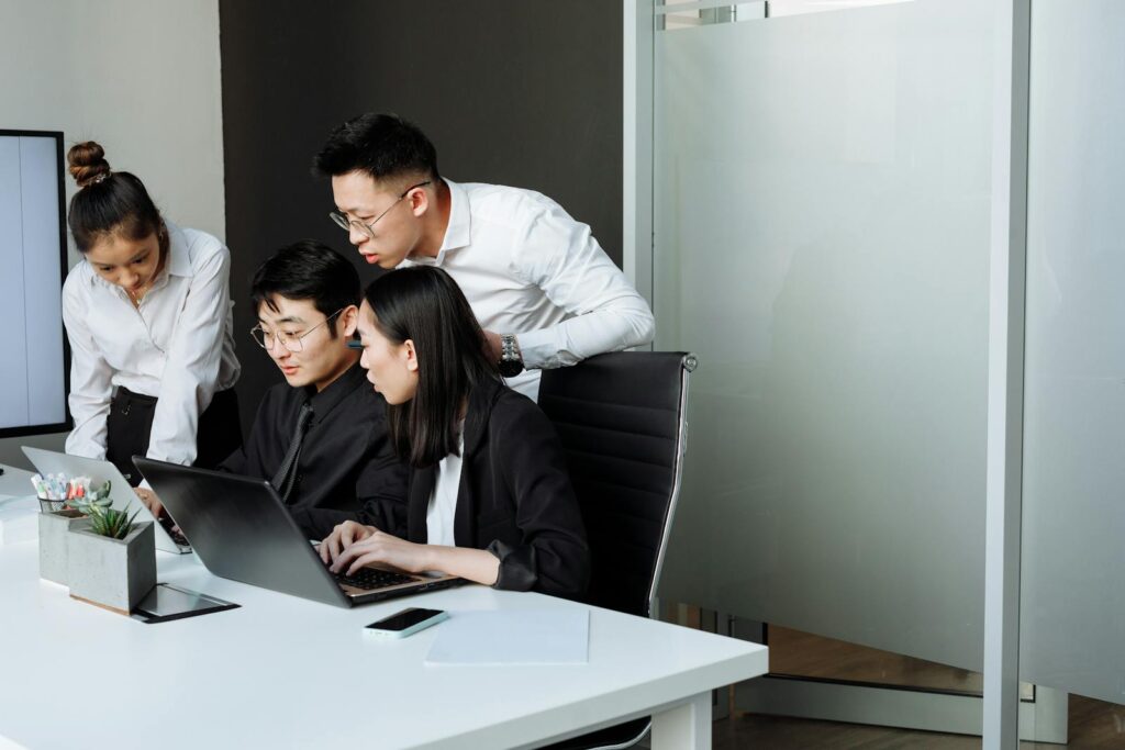 Team of professionals engaged in a collaborative business meeting in a modern office setting.
