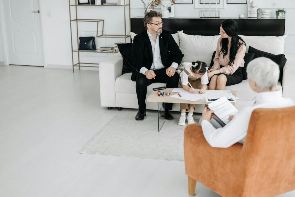 A family discussing adoption plans with a social worker in a cozy office environment.