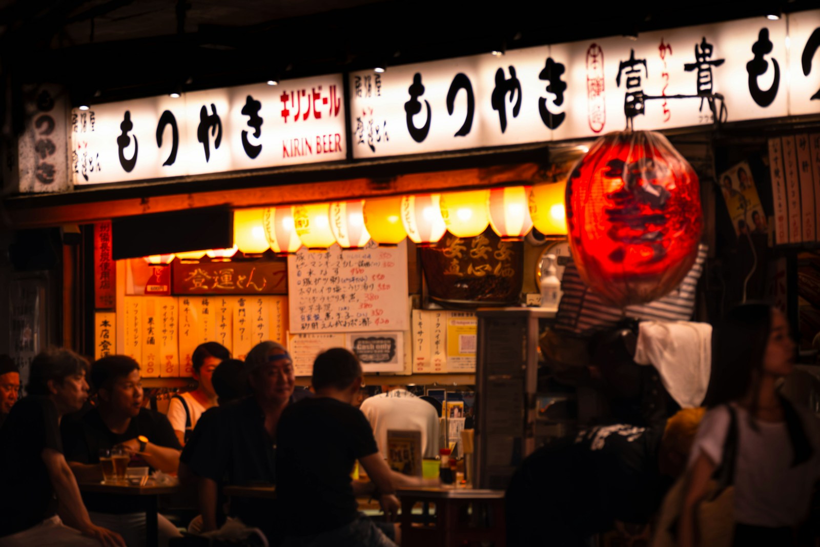 A group of people standing outside of a restaurant