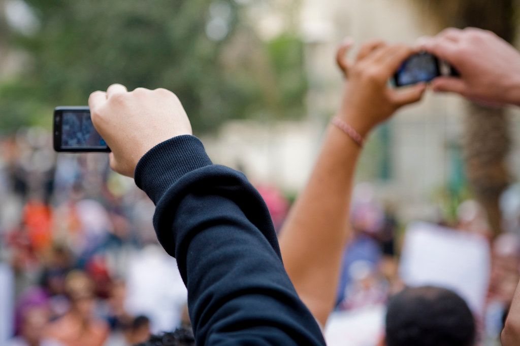 bystanders recording phones