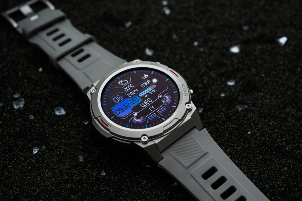 A watch sitting on top of a black surface