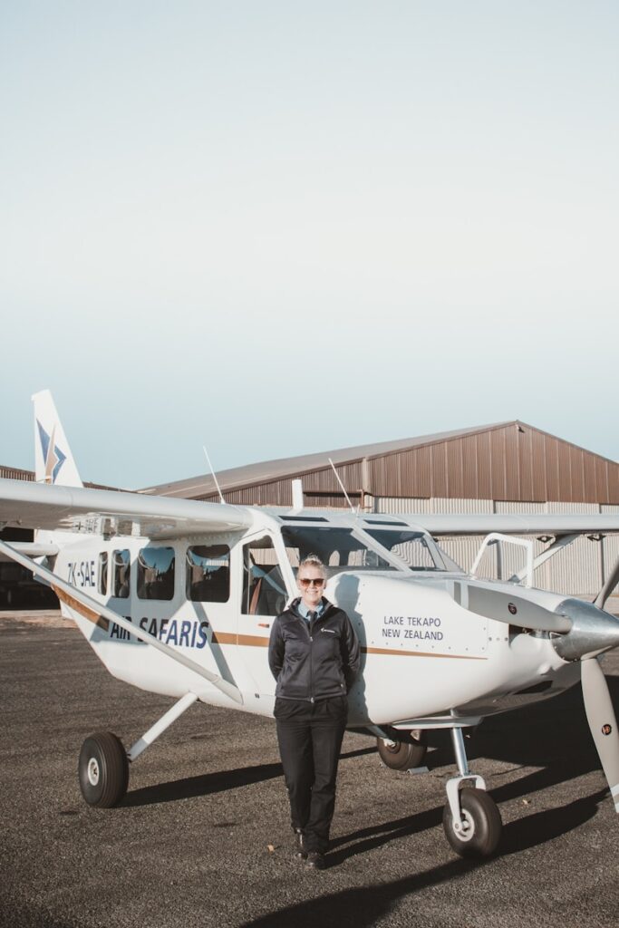 woman standing while leaning on airplane