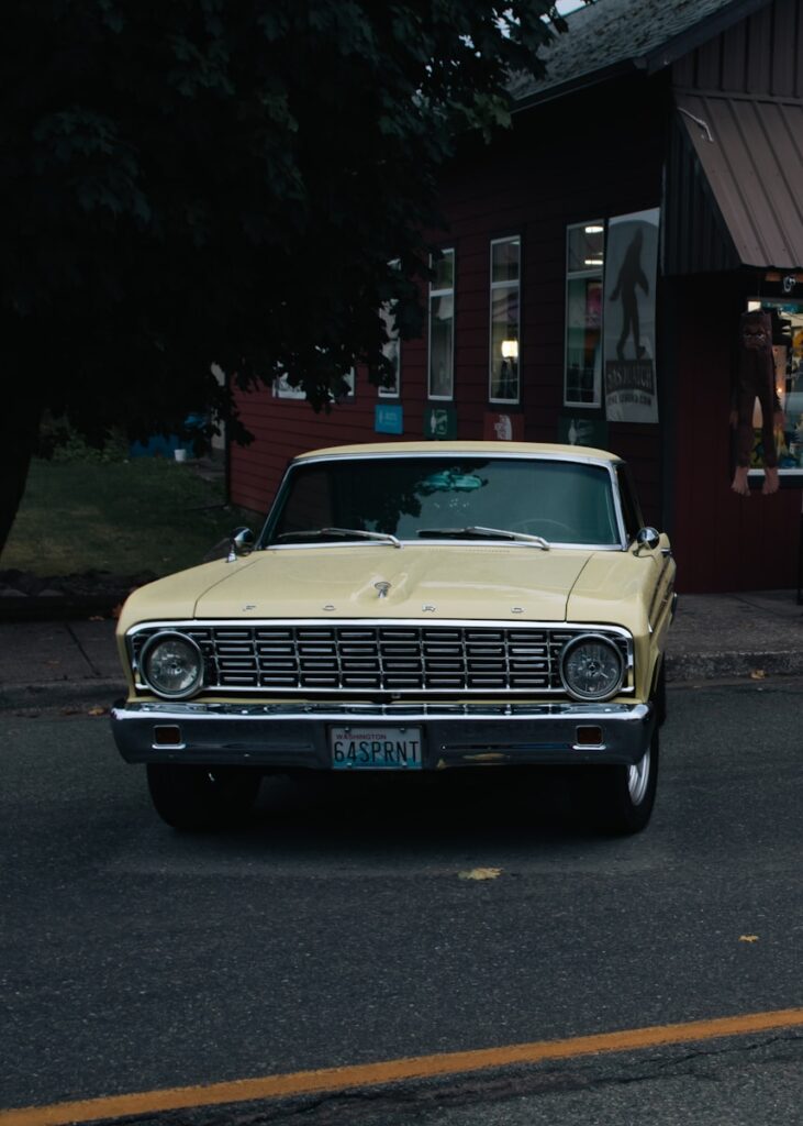 A yellow car parked in front of a building