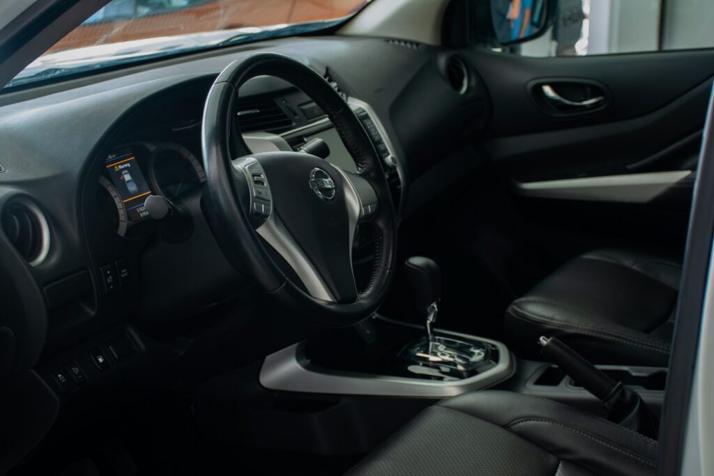 the interior of a car with a steering wheel and dashboard
