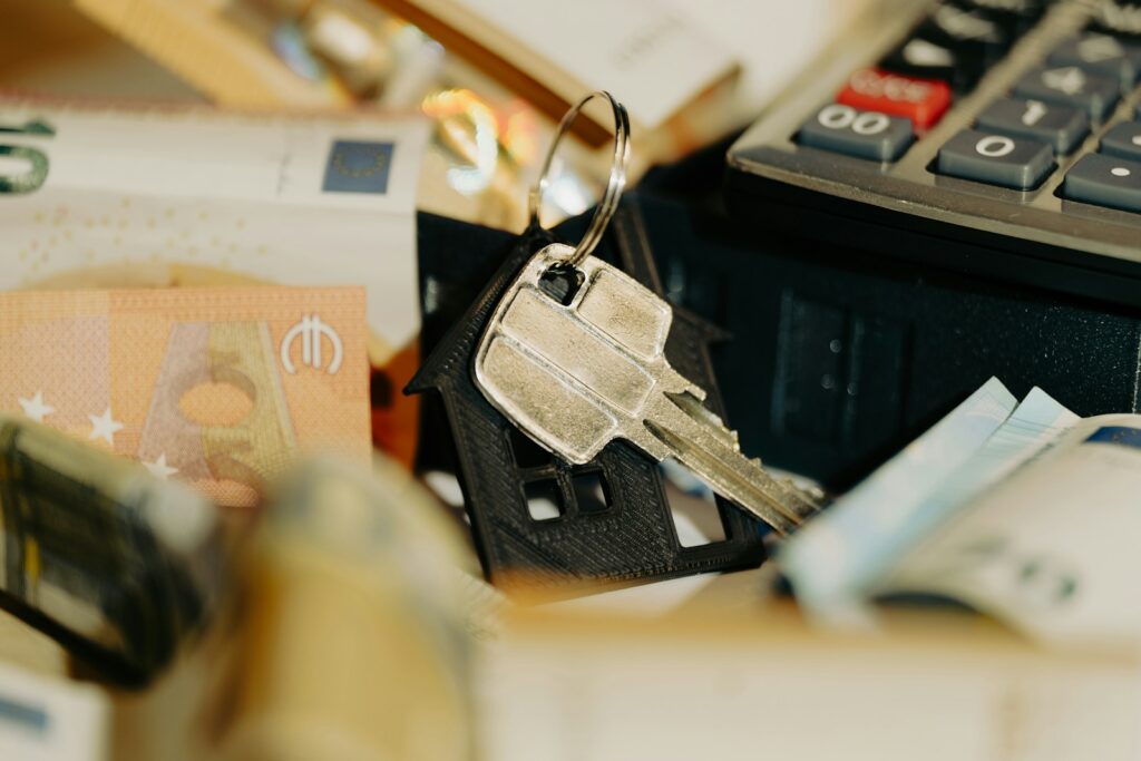 A pile of money sitting next to a calculator