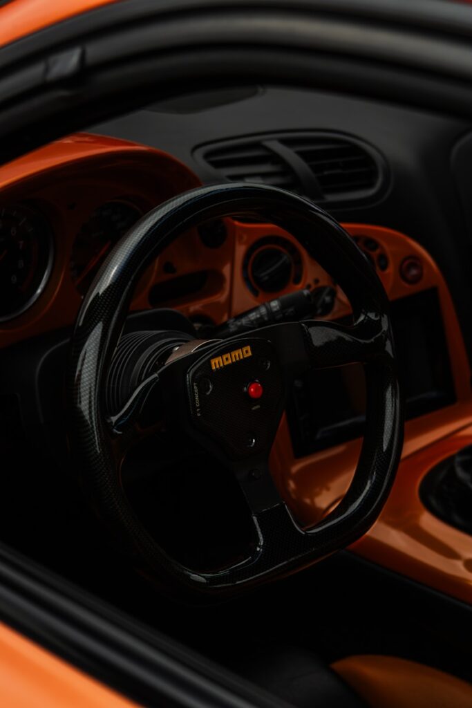 A close up of a steering wheel on a sports car