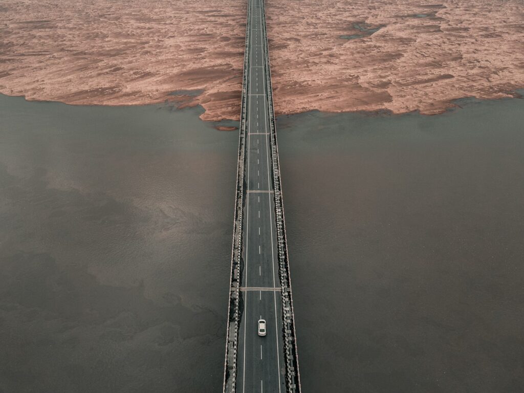 an aerial view of a bridge over a body of water