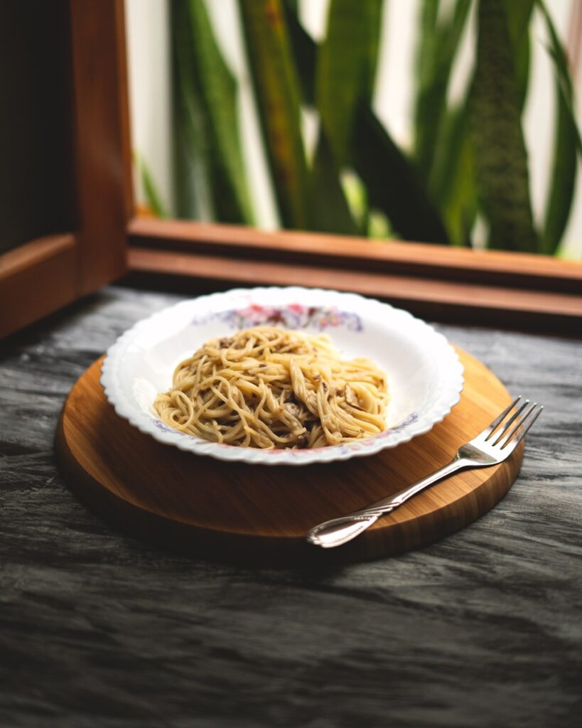 A plate of food on a table near a window