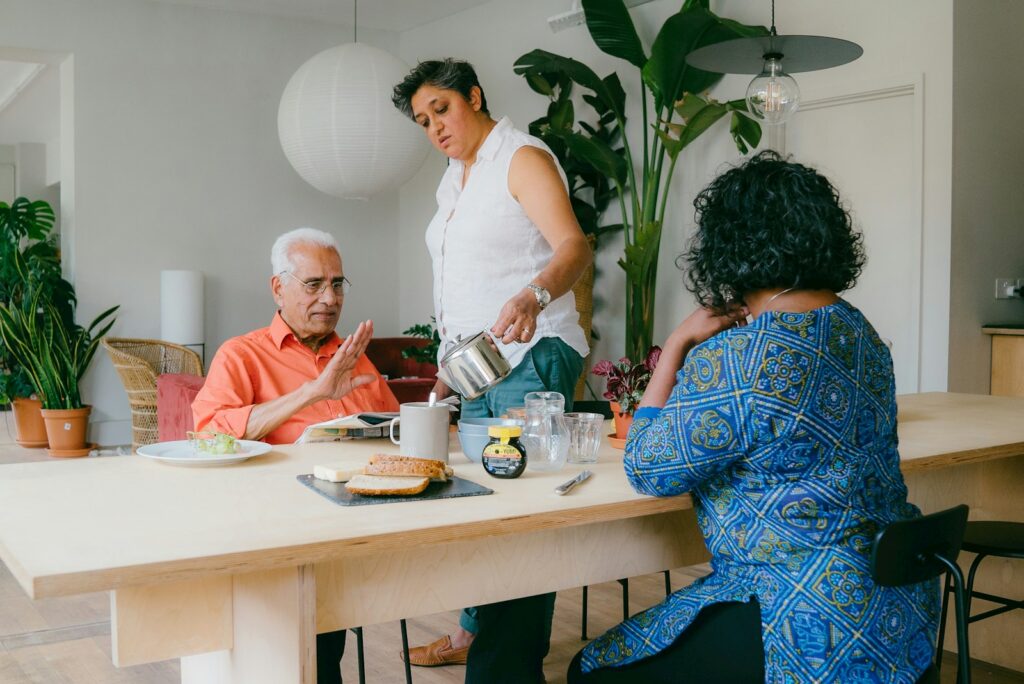 a group of people sitting around a table eating food