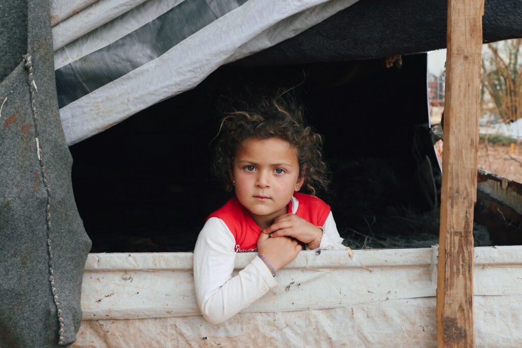 A little girl looking out of a window