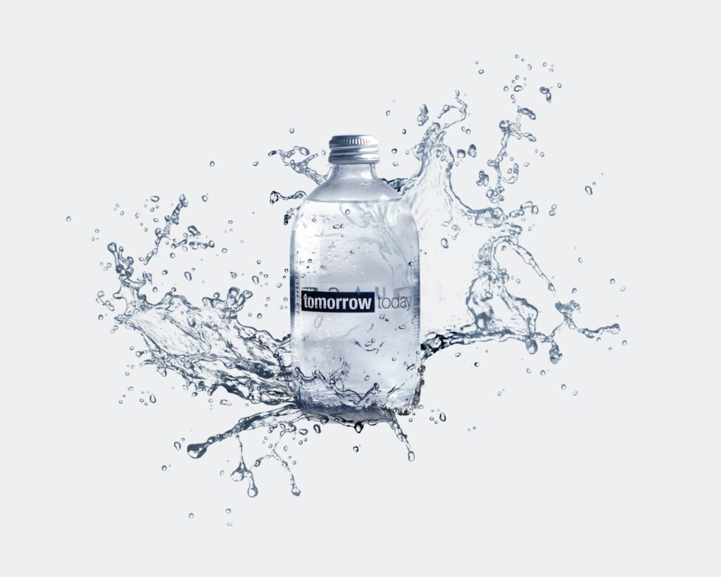a bottle of water with water splashing around it