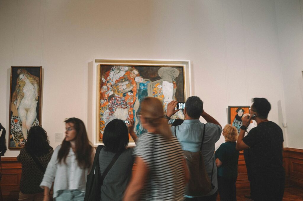 A group of people standing in front of a painting
